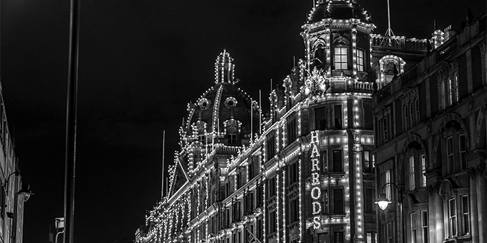Harrods in London at night with lights on, black and white thumbnail