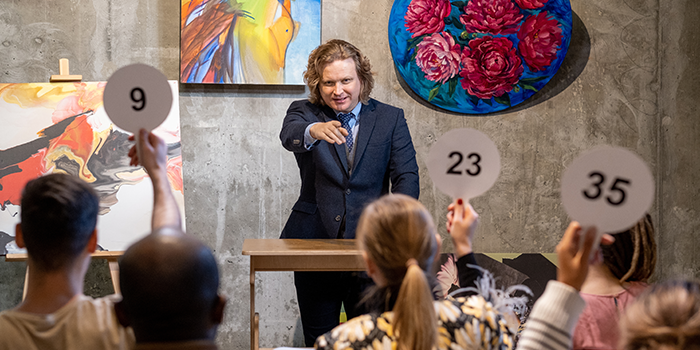 A man at an auction to show the portfolio management we did for a auctioneer company