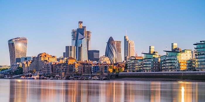 Skyline of modern city buildings at sunrise, illustrating changing operating models in urban development.
