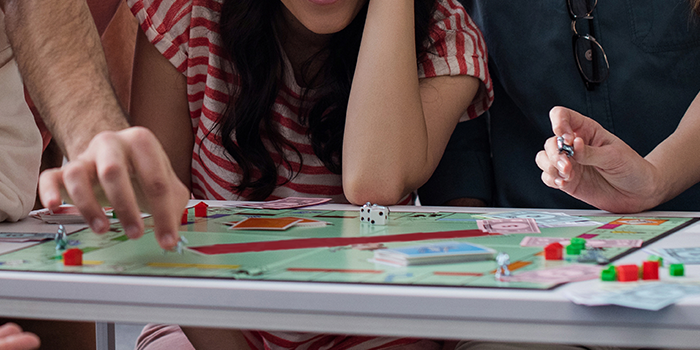 People playing monopoly to show PMO