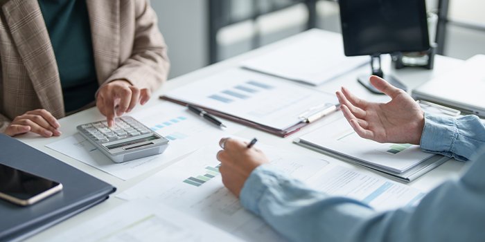 Two people discussing financial matters, to show our customer