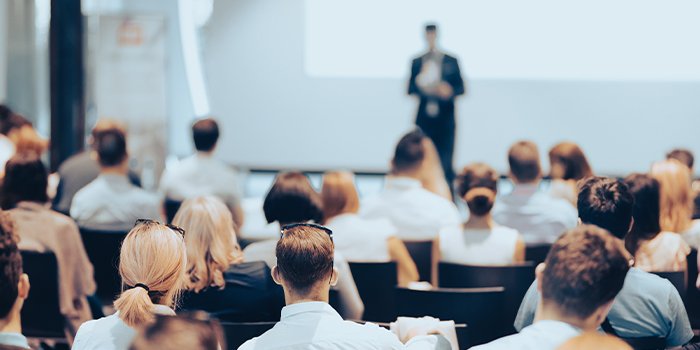 Business speaker giving a talk to show training techniques