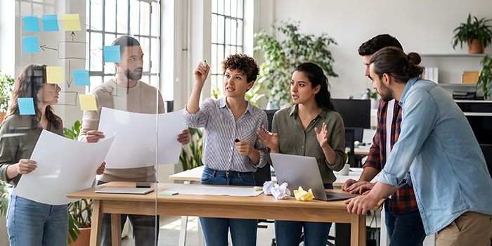 People collaborating around a whiteboard to show a framework